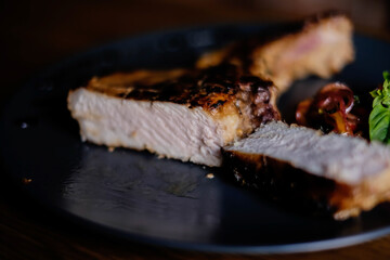 grilled steak on the bone on a blue plate on a wooden table