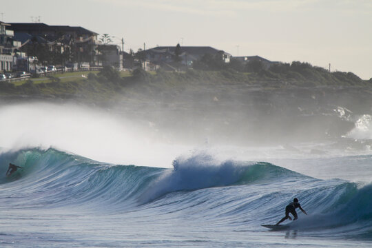 Two surfers facing each other