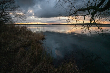 Caspar David Friedrich style atmosspheric picture of a meadow landscape at winter sunset on the shores of Grosser Zernsee in Werder Brandenburg Germany
