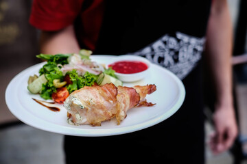 Chicken breast stuffed with cheese sauce and wrapped in pancetta bacon.