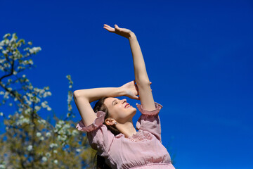 Woman happy smiling joyful with arms up dancing in summer during holidays travel