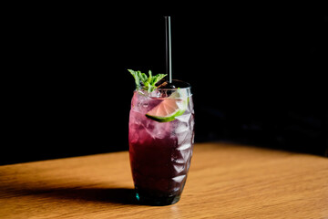 Summer drinks with ice, fresh berries, lemon and berries