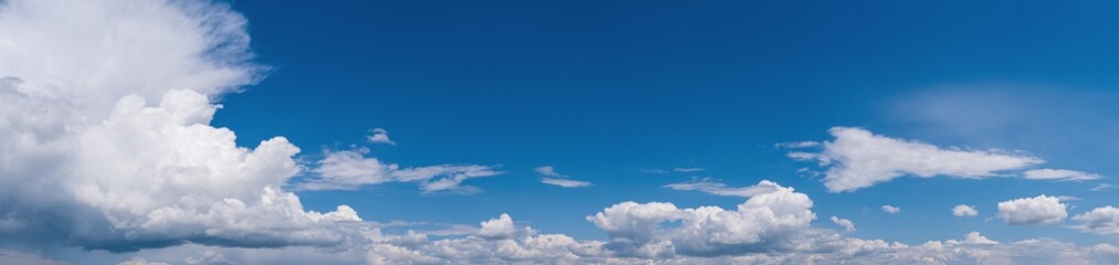 Fuffy clouds in blue sky. Summer good weather skyscape high resolution background.