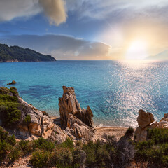 Sunset summer sandy beach and rocky coast near Platanitsi Beach, Sithonia Peninsula, Chalcidice,...