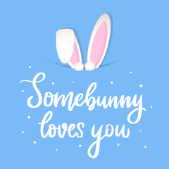 cute hand lettering Easter quote 'Somebunny loves you' deocrated with rabbit's ears on light blue background forgreeting cards, posters, prints, signs, invitations, etc. 