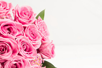 Beautiful bouquet of pink roses flowers with white bow for holiday gift