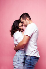 young cheerful caucasian couple together having fun on pink background, guy ang girl modern relationship, lifestyle people concept