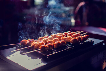 Selective focus to grilled sausages on the barbecue grill. Thai style grilled sausage on stove.