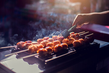 Selective focus to grilled sausages on the barbecue grill. Thai style grilled sausage on stove.