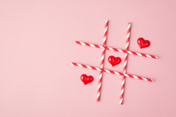 Happy Saint valentines day concept. Above overhead flat lay view photo of crossing straws and small hearts making a line isolated light background with empty space