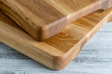 Two wooden cutting board on white wooden table background