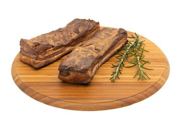 Delicious artisanal whole smoked slab bacon on a cutting block.