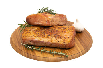 Smoked ham on a rustic wooden board with fresh rosemary.