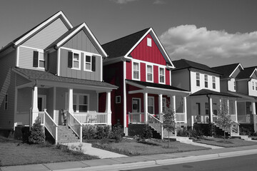 Selective red color in a black and white photo of a row of suburban houses