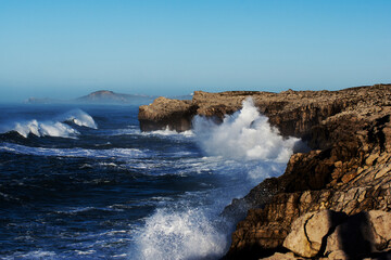 Fototapeta na wymiar Huge waves hitting the cliff and exploding