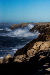 Huge waves hitting the cliff and exploding