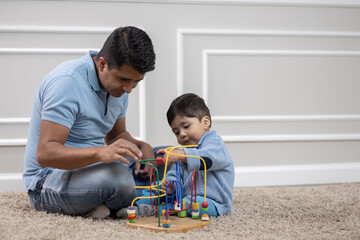 Mexican father and child playing with blocks
