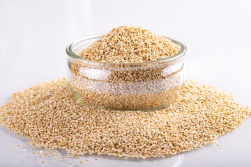 White quinoa background in a glass jar on white table