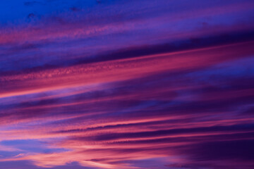 
Bright sunset sky. Clouds pink color texture background