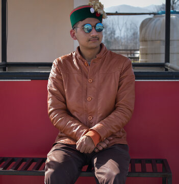 Indian himachali boy wearing traditional phadi topi (hat) and blue sunglasses