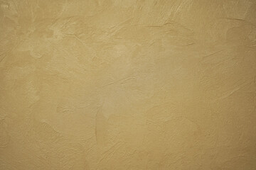 Obraz premium Abstract gold background with plaster texture on wall