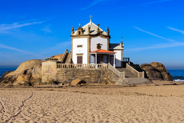 Fototapeta na wymiar church in the sand Chapel of the Lord of the Stone (Senhor da Pedra)in Miramar Gaia -Portugal 