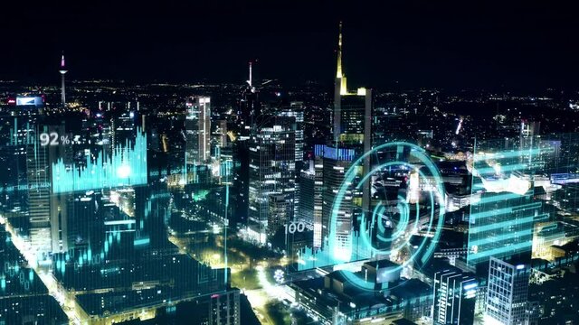 Aerial view with animated financial infos of stock market trading candlestick bear bull market of Skyline Frankfurt at night shot in 4k