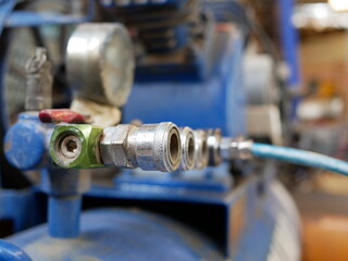 closeup of air compressor system in garage.
