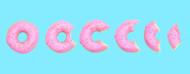 Whole donut and half-eaten donuts with pink glaze and colored sprinkles on blue background