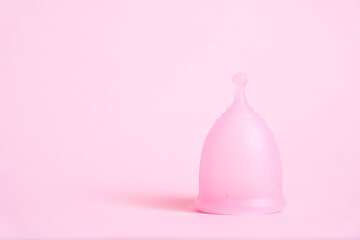 Menstrual cup on pink background. Alternative feminine hygiene product during the period. Women health concept