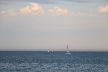 Fototapeta premium yachts and boats float on the ocean under a beautiful sky