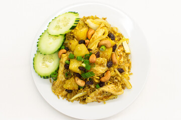 Pineapple fried rice with chicken served in white plate on white background.