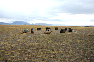 An ancient temple lying in the autumn steppe in the form of a cannon fence and a pedestal with a...