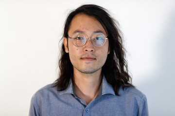 Portrait of young hipster Asian  man wearing eyeglasses in casual clothing on white background