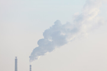 Air Pollution in the City . Steam of industrial smoke comes from the pipes