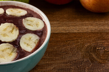 Acai (Açai) with Banana, Brazilian Tradicional Fruit with Tropical Fruits on a Bowl on  Wooden Table 