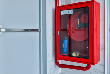 Hydrant with water hoses and fire extinguish equipment. Fire safety equipment in the red box on...