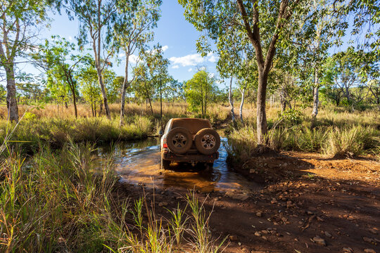 Derby, WA, Australia - Jul 2, 2015: A Toyota Landcruiser fords a deep creek near Mount Hart on the iconic Gibb River Road.