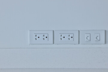Focus white plug socket 2 channels on the wood wall. electricity for house and city. charging energy concept. image for background, copy space.