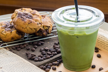 Iced Matcha green tea in takeaway cup. Glass of green tea smoothies with fresh green tea. Homemade Iced Matcha Latte Tea with Milk.