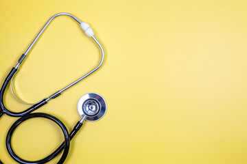 Stethoscope isolated on yellow background. Medical concept