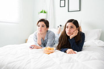 Obraz na płótnie Canvas Female best friends watching movies during a sleepover