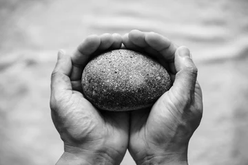 Fototapeten person holding stones © joowon kim
