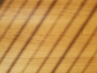 Texture of wooden table background with blurred striped light.