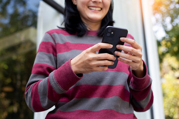 using cell phone hand holding mobile texting message contact us.chatting,search internet...