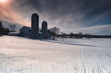 Rural landscapes featuring winter waterfalls and cascades, with barns and snow covered fields in Southern Ontario Canada near Kingston