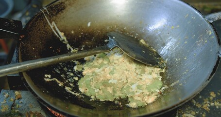 Stir frying Bitter melon With Eggs in frying pan at the kitchen, Thai traditional local food