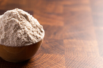 Spelt Flour in a Wooden Bowl on a Wooden Butchers Block