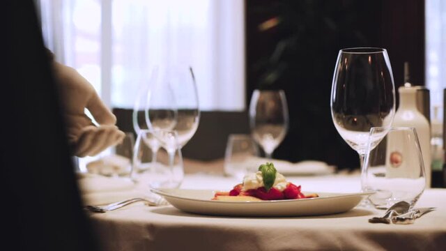 Octopus with stracciatella and vegetables. Octopus dish. Serving dish in a restaurant. Ready dish on the table.