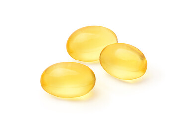 Three golden color oil in soft gel capsule isolated on white background. Clipping path